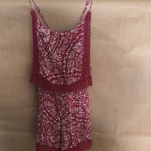 This item is a red patterned romper